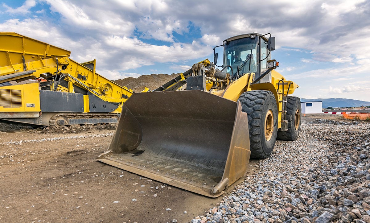 Yellow wheel loader at a construction site.